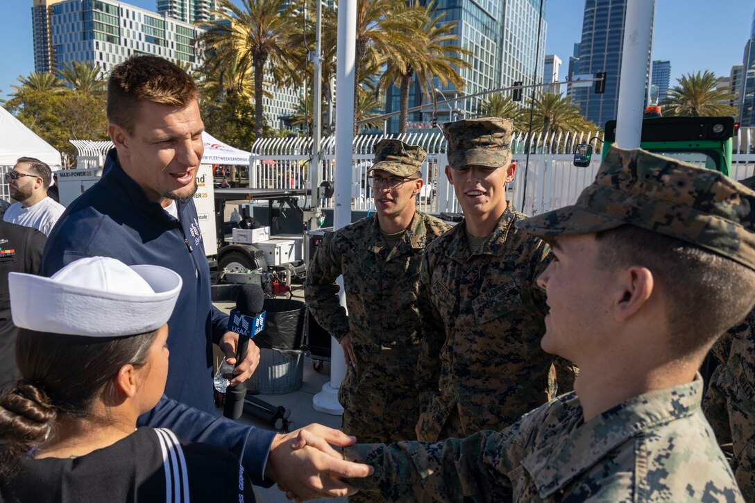 Rob Gronkowski, a former National Football League player, meets with U.S. Marines and Sailors during Fleet Week San Diego at Broadway Pier, San Diego, Nov. 9, 2024. FWSD is an opportunity for San Diego residents and tourists to meet their Navy, Marine Corps and Coast Guard teams and experience America’s sea services. During fleet week, service members participate in various community relations events, showcase capabilities and equipment to the community, and enjoy the hospitality of San Diego and the surrounding area. (U.S. Marine Corps photo by Sgt. Gabriel Tavarez)