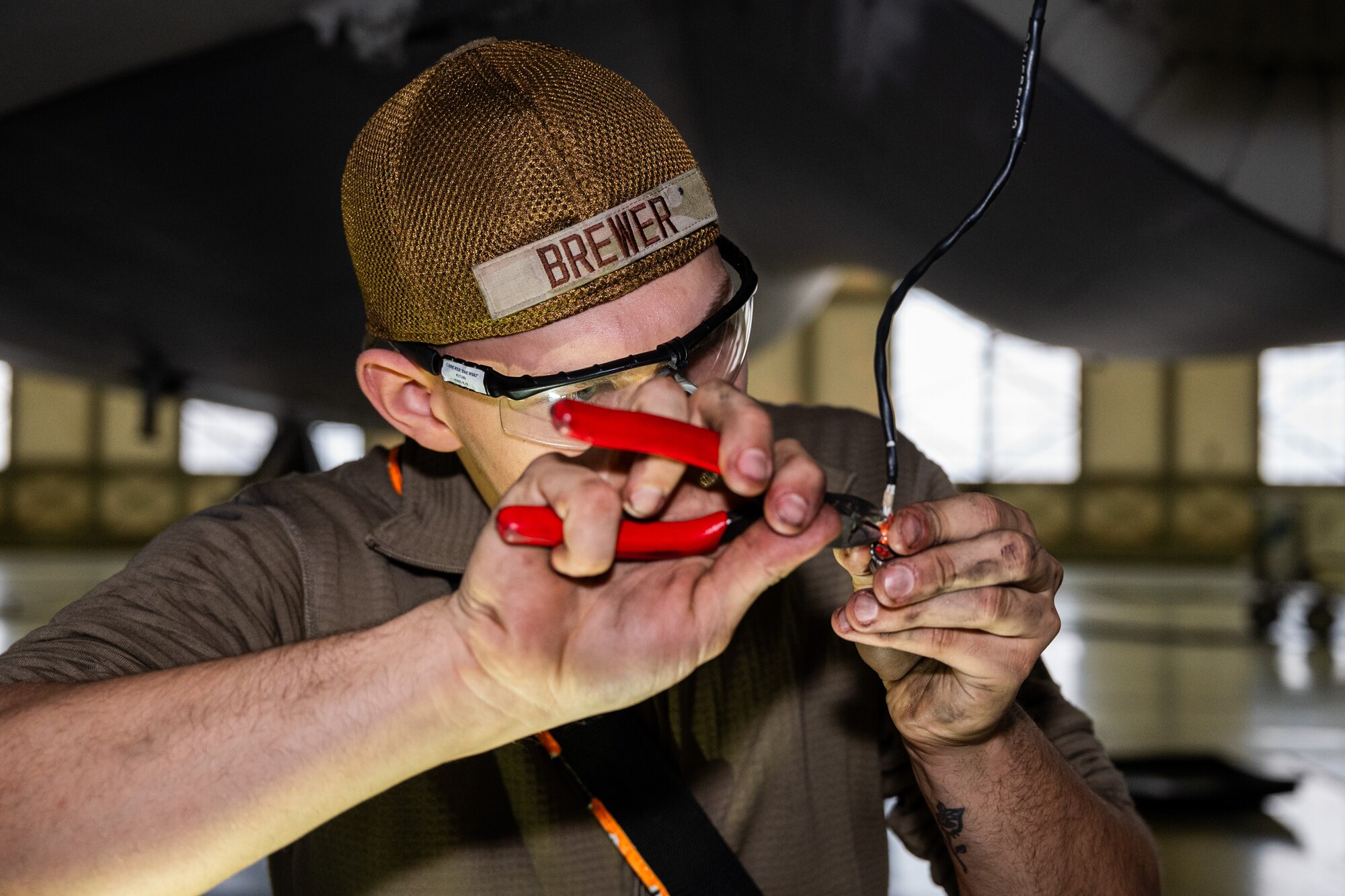 U.S. Air Force Airman 1st Class Christopher Brewer, 62d Aircraft Maintenance Squadron electrical and environmental technician, removes wire molding in preparation for the landing gear removal at Joint Base Lewis-McChord, Washington, Nov. 13, 2024.
