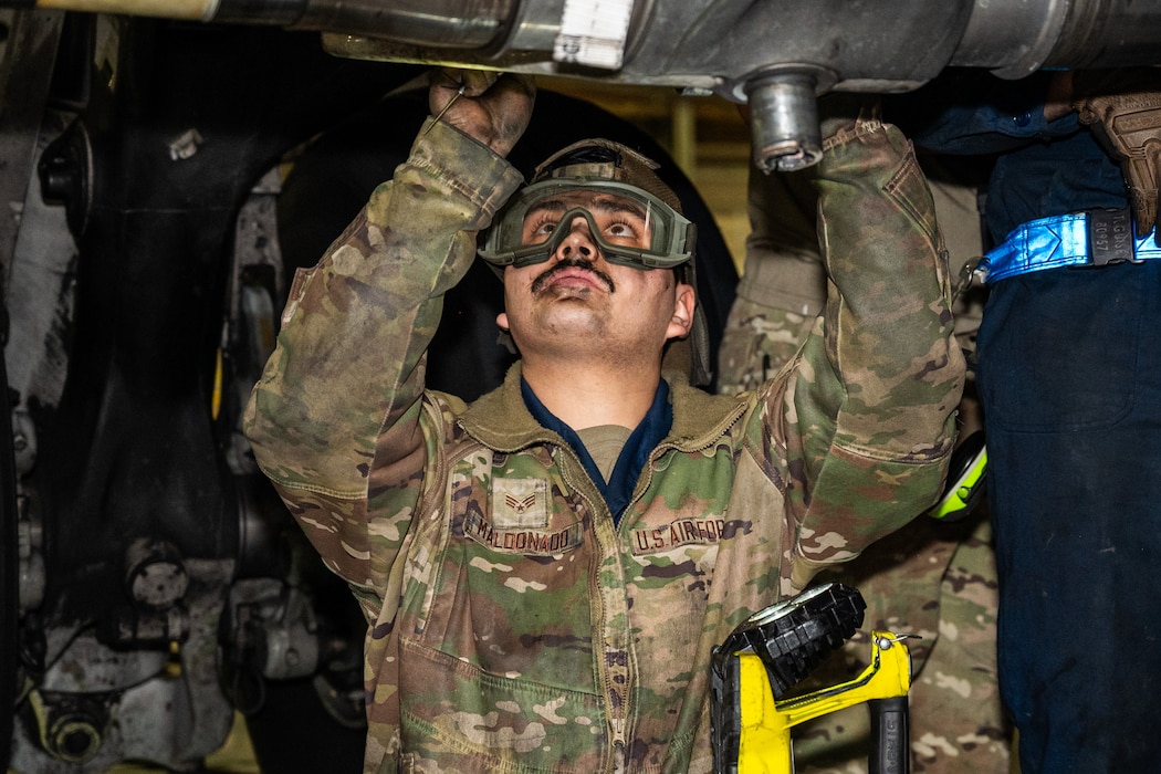 U.S. Air Force Senior Airman Gerardo Maldonado, 62d Aircraft Maintenance Squadron dedicated crew chief, works to remove the old landing gear axle at Joint Base Lewis-McChord, Washington, Nov. 13, 2024.