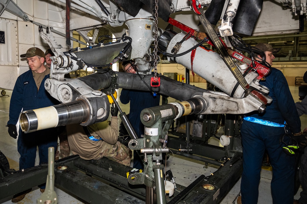 Technicians prepare to remove a main landing gear axle from a C-17 Globemaster III at Joint Base Lewis-McChord, Washington, Nov. 13, 2024.