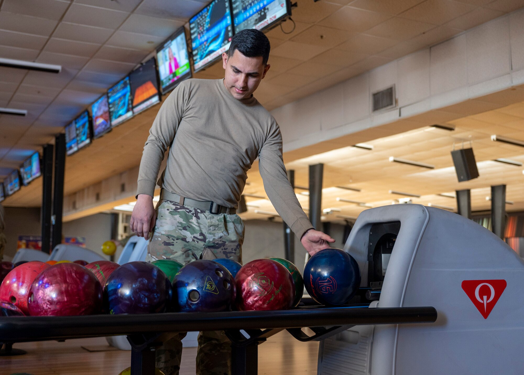 A U.S. Airmen selects a bowling ball during Airman’s Week at Davis-Monthan Air Force Base, Arizona, Nov. 13, 2024. Airman’s Week was a week of recreational events organized by the Desert Lightning Team 5/6 and sponsored by the Chiefs Group and First Sergeants Council for Airmen on base to enjoy. (U.S. Air Force photo by Senior Airman William Finn V)