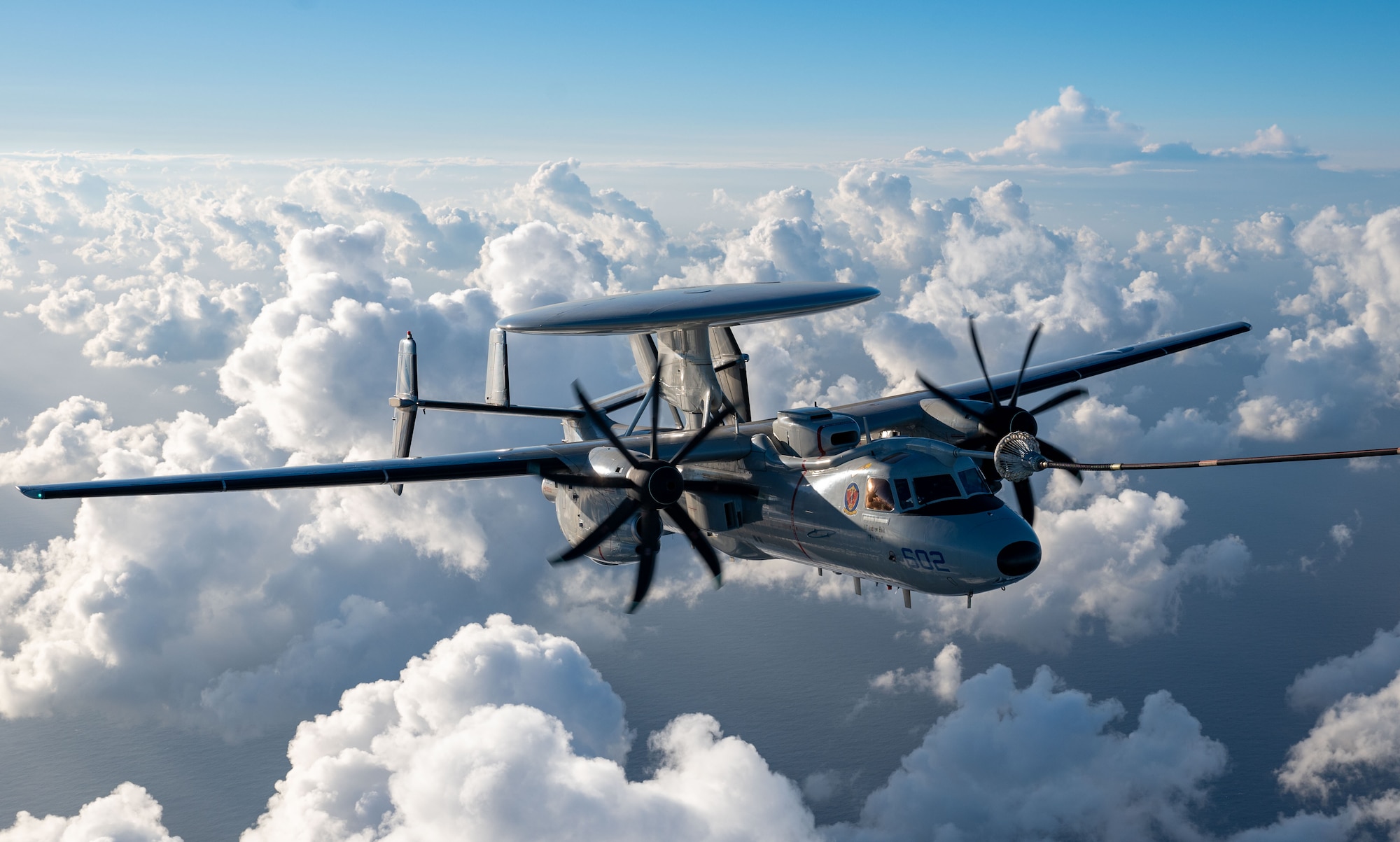 A U.S. Navy E-2D Advanced Hawkeye aircraft assigned to the VAW-121 Bluetails receives fuel from an HC-130J Combat King II aircraft