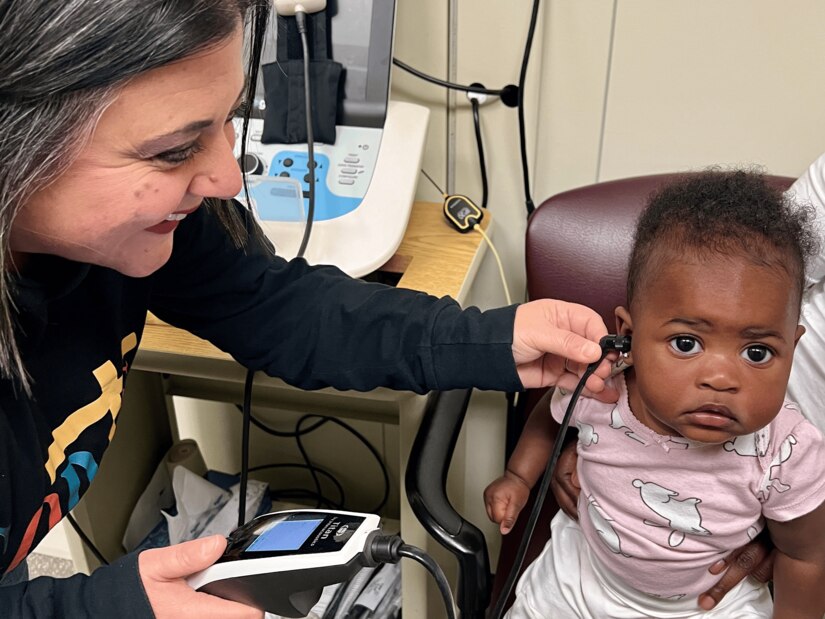 Doctor checks a child's hearing