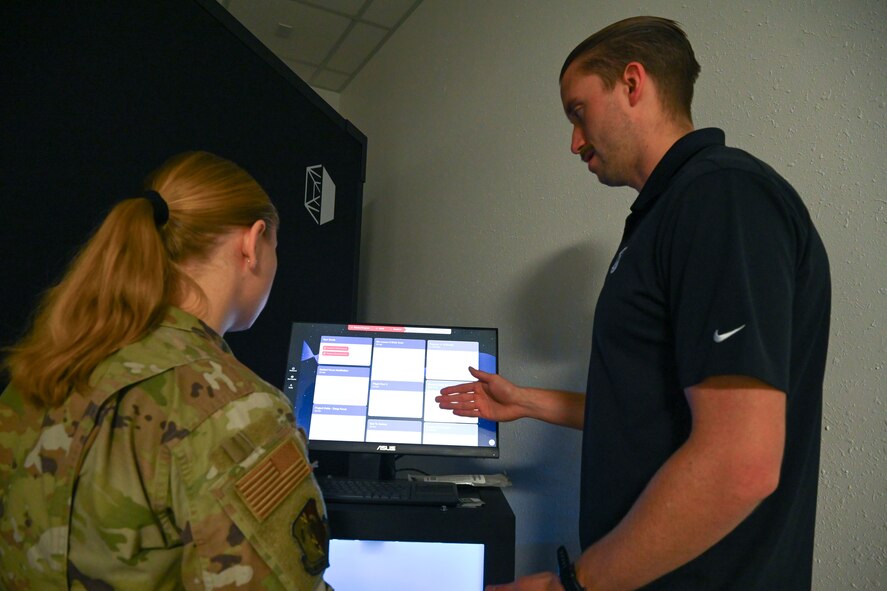 U.S. Air Force Staff Sgt. Shelby Moore, 5th Mission Support Group NCOIC of religious affairs (left), receives feedback about her MindGym session from Brandon Murphy, Lumena Inc.’s head of growth (right), at Minot Air Force Base, North Dakota, Nov.15, 2024.  The goal of the MindGym is to provide Team Minot with an additional tool to build resiliency and improve mental health.