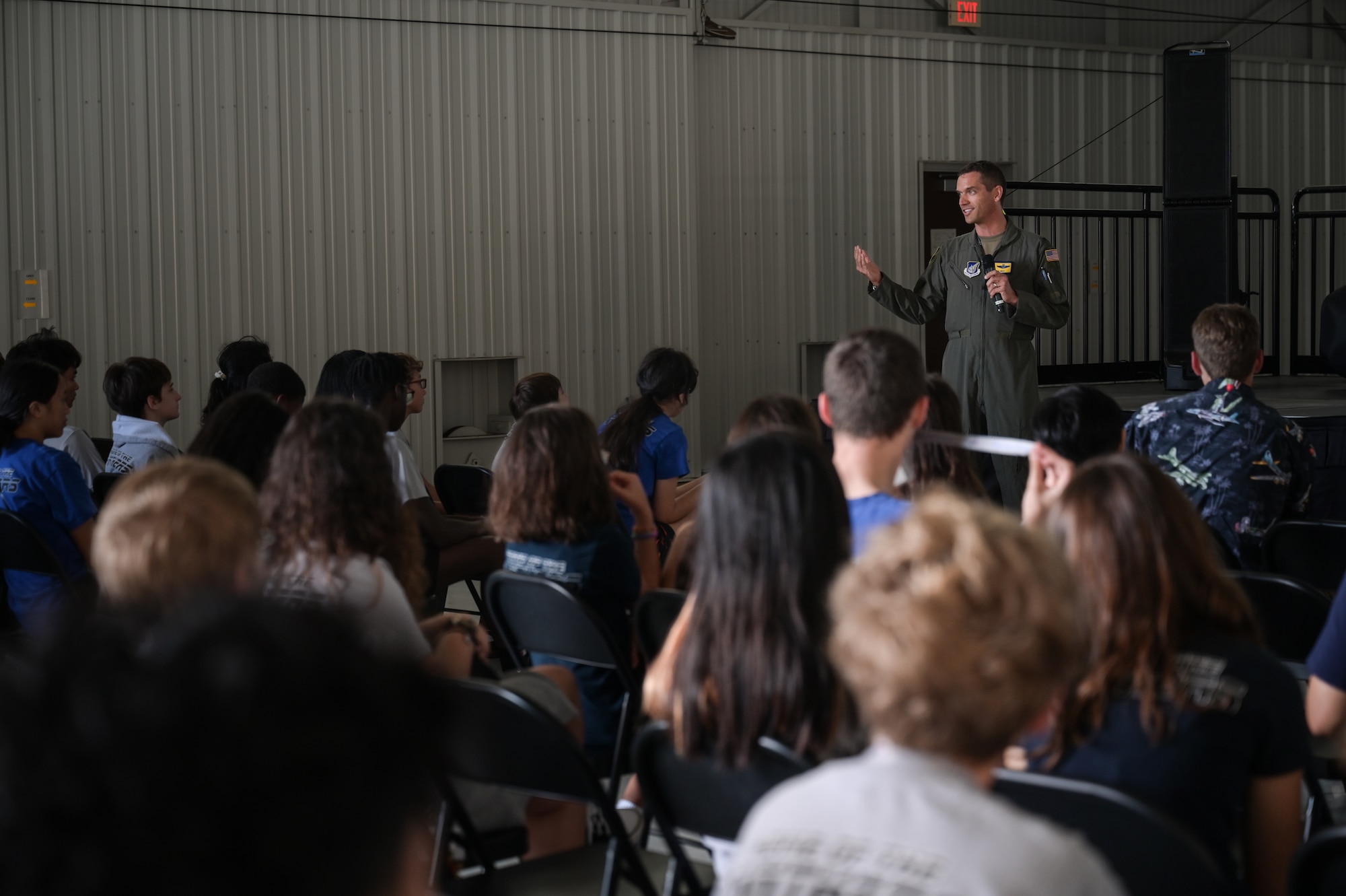 Airman speaks in front of students.