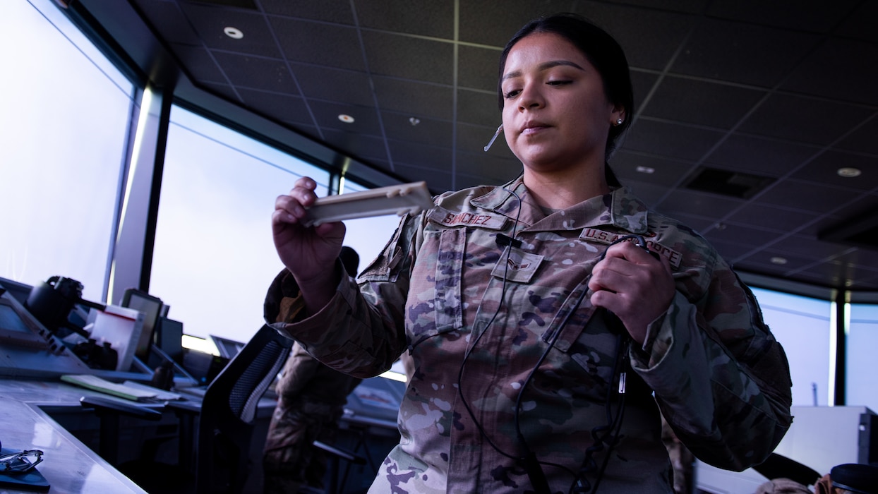 Airman holding outbound aircraft flight information in hand