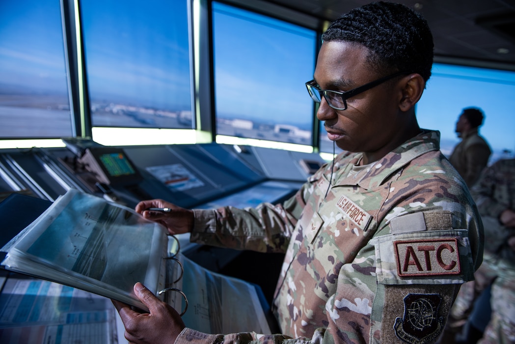 Airman reviews documents in air traffic control tower