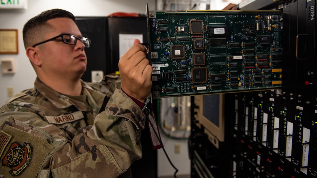 Airman inspects circuit card