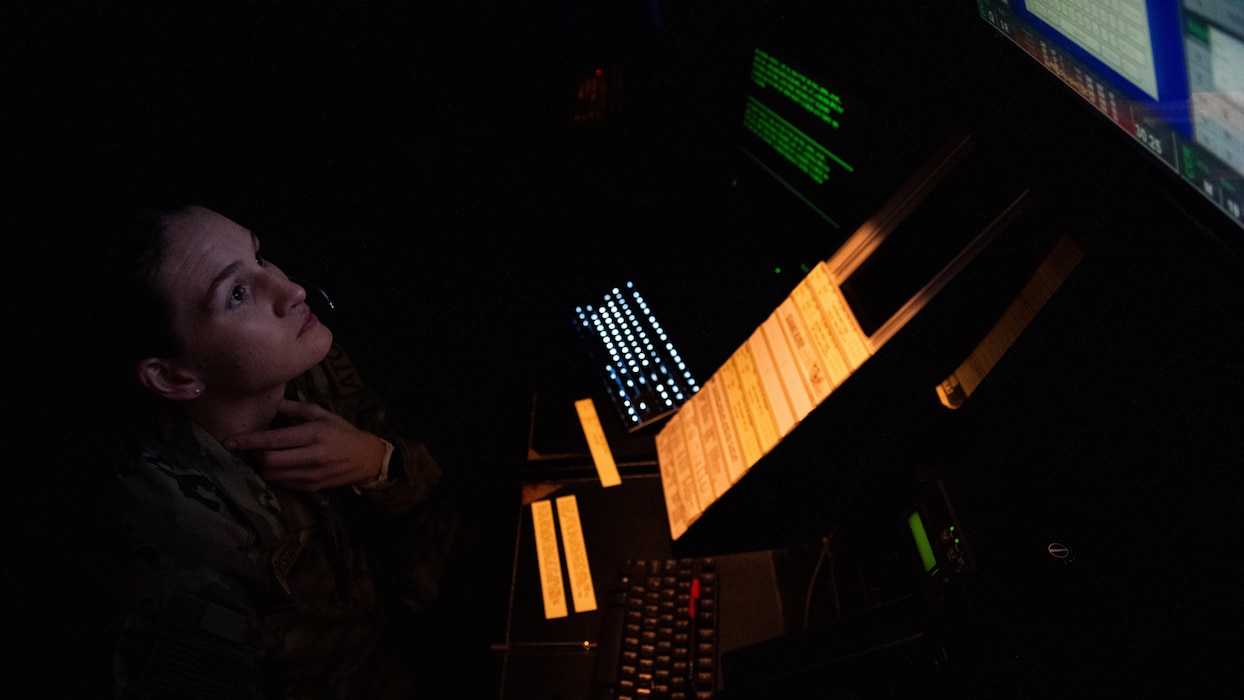 Airman views radar screen in low lights