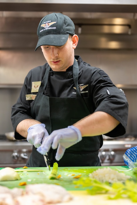 Airman slices celery.