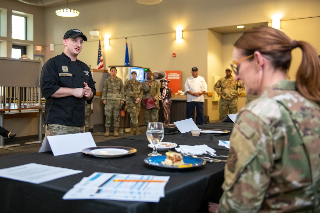 Airman presents food to judges.