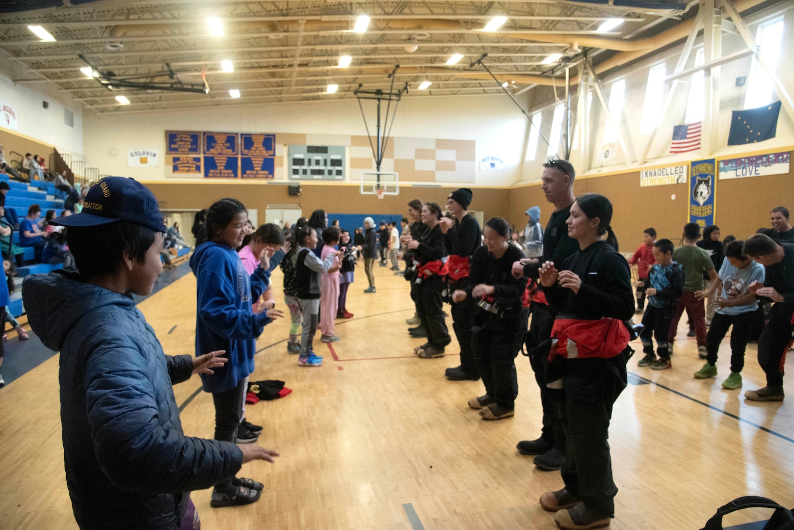 Coast Guard Cutter Stratton (WMSL 752) crew members engage with community members at an elementary school in Savoonga, Alaska, Sept. 20, 2024. Stratton’s crew conducted community relations engagements in the remote Alaskan communities of Savoonga, Teller and Brevig Mission where crew members met with tribal and city council leadership, volunteered at elementary schools, provided training in water and boating safety, participated in community-wide events including a high-latitude half-marathon, and learned about Inupiat culture, aiding in the service’s understanding of the communities and how to optimize support for remote Alaskan villages. U.S. Coast Guard courtesy photo.