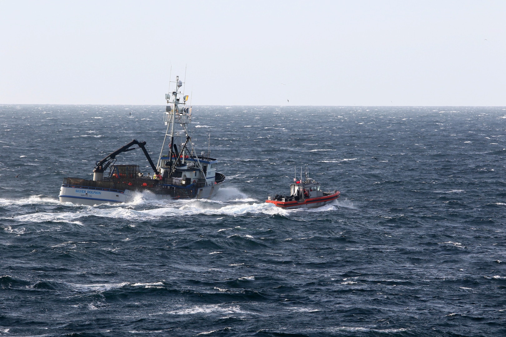 Coast Guard Cutter Stratton (WMSL 752) conducts a boarding at sea near Unalaska Island, Alaska, Oct. 10, 2024. Stratton conducted 20 boardings of commercial fishing vessels and foreign trans-shipment vessels enforcing safety and fishing regulations during the cutter’s 110-day patrol of the region. U.S. Coast Guard courtesy photo.