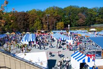 People walk around a festival area.