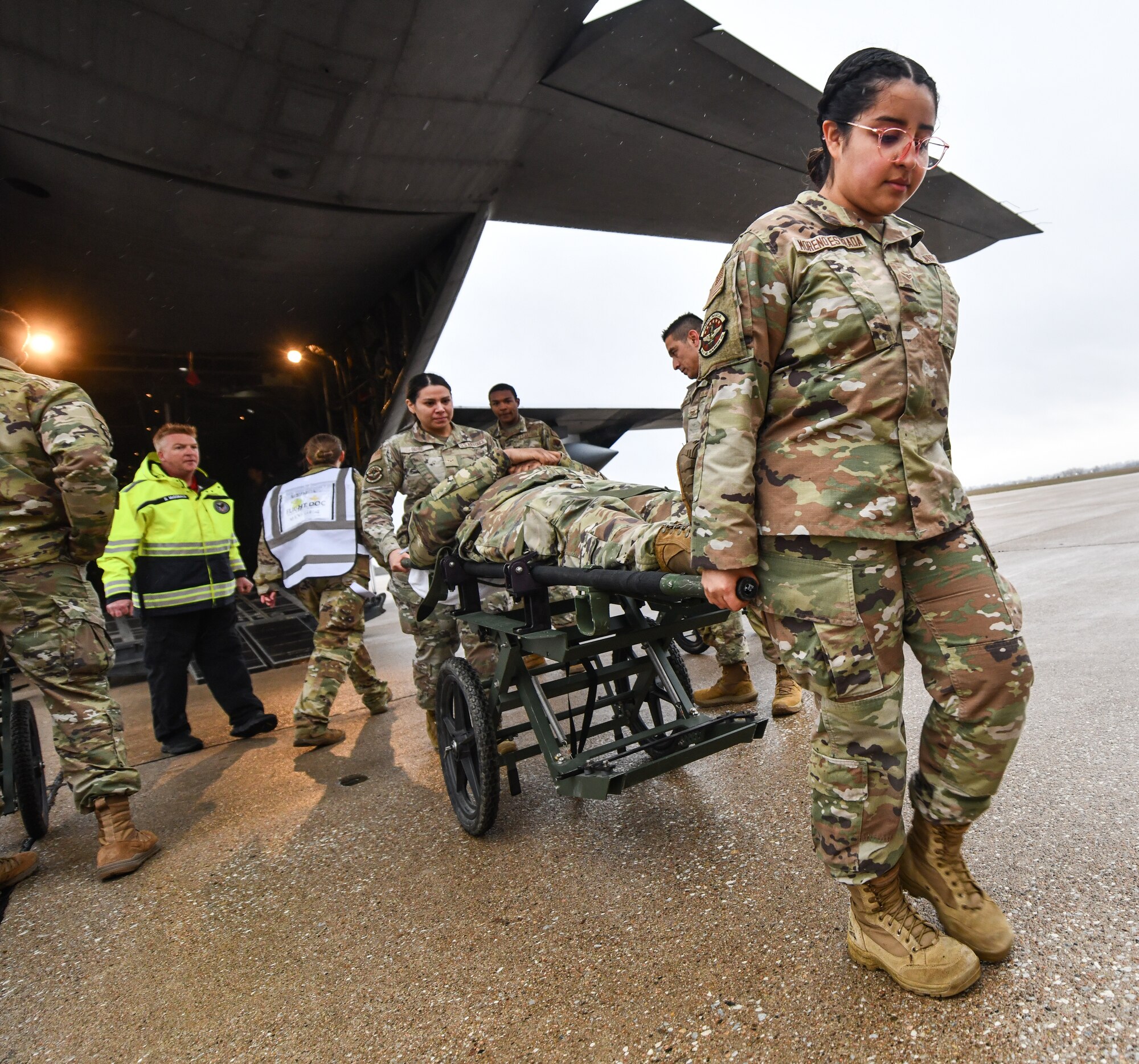55th Medical Group personnel wheel a patient on a stretcher during a National Disaster Medical System exercise at Offutt Air Force Base, Nebraska Nov. 13, 2024 . The Omaha area is conducting an exercise to determine the preparedness to support an overseas conflict by moving military casualties into the civilian health care network. Participants from local, state, and federal response agencies teamed up with Air Force and the Nebraska Air National Guard to ensure the nation’s capability to support a war effort. (U.S. Air Force photo by Chad Watkins)