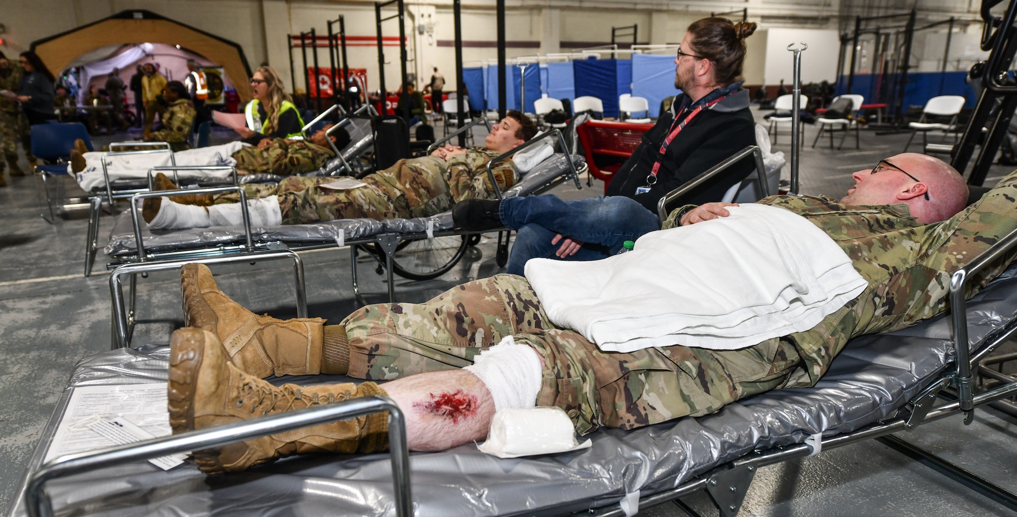 Patients wait for care at Offutt Air Force Base on Nov. 13, 2024, during a National Disaster Medical System exercise. The Omaha area is conducting an exercise to determine the preparedness to support an overseas conflict by moving military casualties into the civilian health care network. Participants from local, state, and federal response agencies teamed up with Air Force and the Nebraska Air National Guard to ensure the nation’s capability to support a war effort. (U.S. Air Force photo by Chad Watkins)
