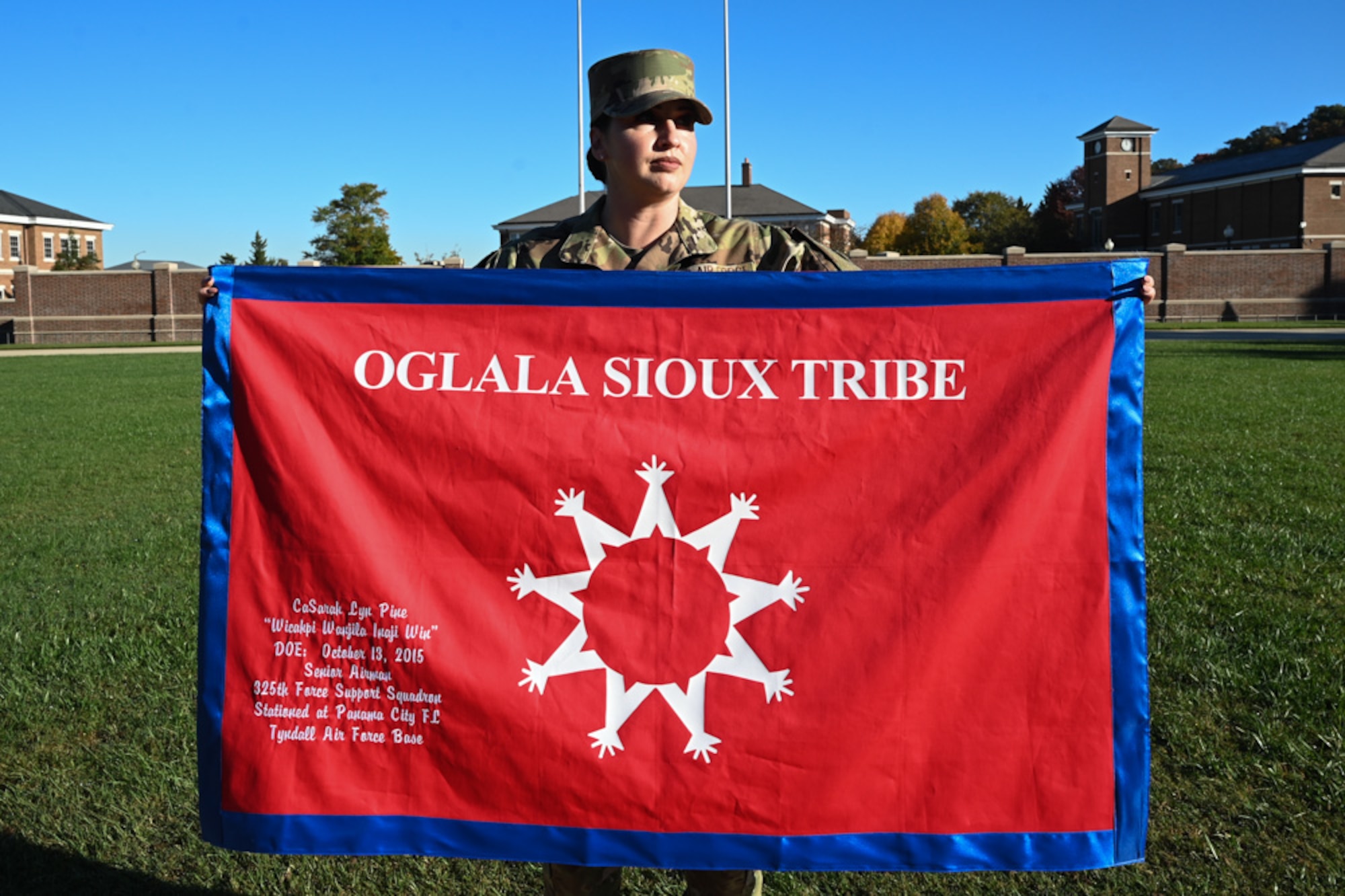 U.S. Air Force Staff Sgt. Casarah Pine, flight instructor for the USAF Honor Guard at Joint Base Anacostia-Bolling, holds a Oglala Sioux Tribe flag on the ceremonial lawn at Joint Base Anacostia-Bolling,Washington, D.C., Oct. 25, 2024. The Oglala Sioux is a subtribe of the Lakota people and historically lived as nomadic buffalo hunters on the Great Plains. (U.S. Air Force photo by Airman 1st Class Shanel Toussaint)
