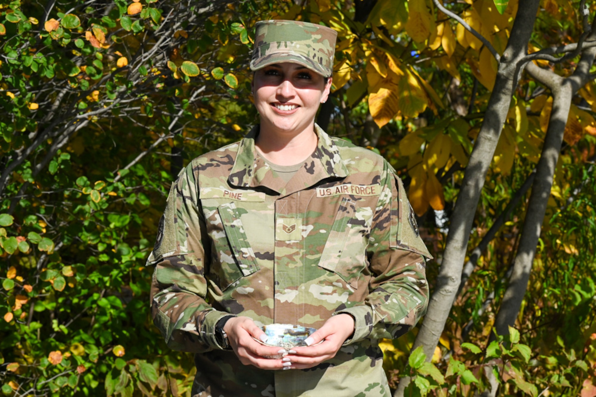 U.S. Air Force Staff Sgt. Casarah Pine, flight instructor for the USAF Honor Guard at Joint Base Anacostia-Bolling, holds an abalone bowl with sage to burn for an energy cleansing at the Native American Veterans Memorial in Washington, D.C., Nov. 7, 2024. Sage burning, or smudging, is essential in Native American culture as it serves as a deeply symbolic and spiritual practice that serves as a tool for healing, cleansing, and connecting to the spirit world. (U.S. Air Force photo by Airman 1st Class Shanel Toussaint)