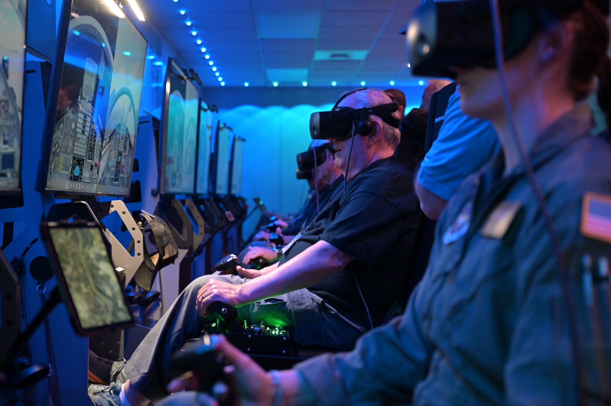 Several retired Air Force pilots use the virtual reality fighter training simulators at the 50th Flying Training Squadron