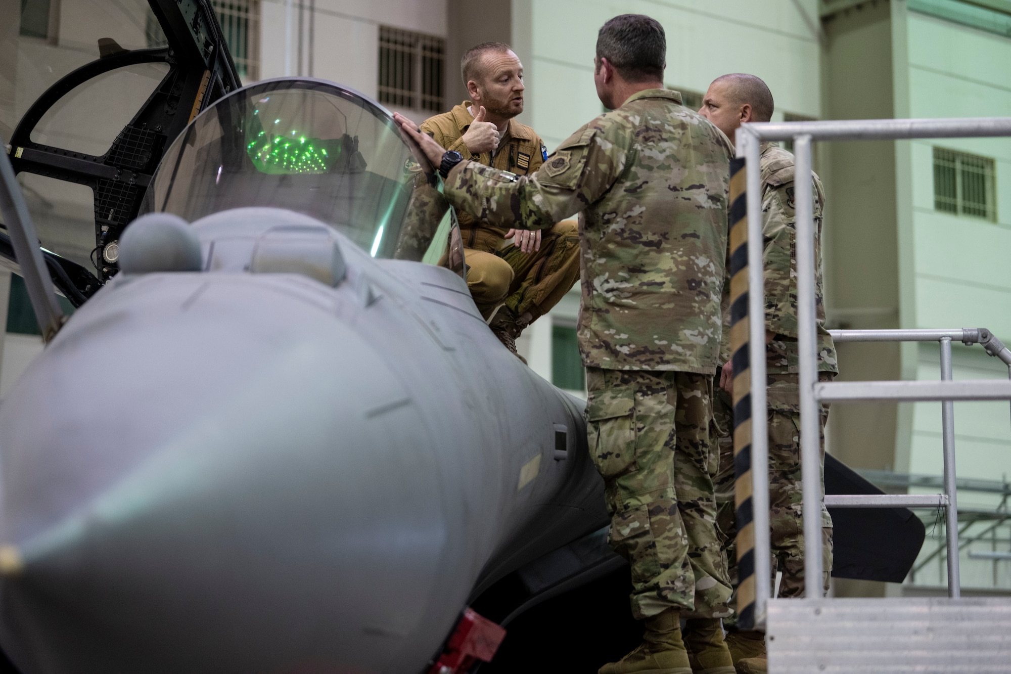 Base Aerienne 104 commander Col. David Pappalardo (left) talks with 380th Air Expeditionary Wing leadership, Col. Paul Sheets, commander, and Chief Master Sgt. Joshua Skarloken, command chief (right), during an engagement.