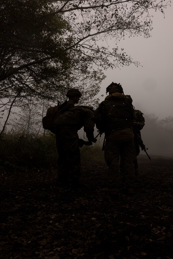 U.S. Marines plan a patrol route during exercise Shinka 24 on Combined Arms Training Center Camp Fuji, Japan, Oct. 30, 2024. At Shinka 24, Fuji Training Center provides 4th Marines units the opportunity to execute company defensive operations against a peer-level adversary force with detailed after-action analysis to refine Stand-in Force tactics.