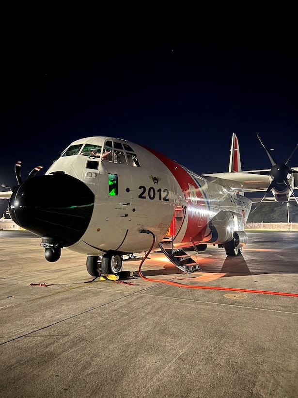 A U.S. Coast Guard Air Station Barbers Point HC-130 Hercules airplane crew conducts pre-flight checks on the ramp at Air Station Barbers Point before launching for a medivac on Midway Atoll, Nov. 17, 2024. The U.S. Coast Guard responded to a medivac request for a man experiencing symptoms of a stroke or seizure on Midway Atoll. (U.S. Coast Guard photo by Cmdr. Victor Yaguchi)