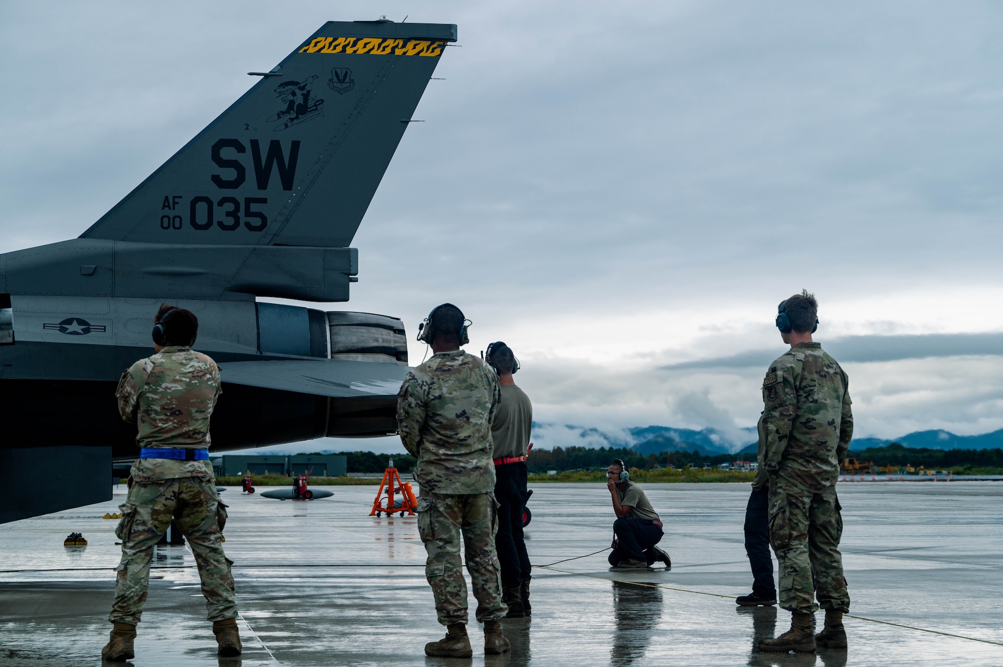 Members of the 77th Expeditionary Fighter Generation Squadron standby to assist with pre-flight inspections for an F-16 Fighting Falcon at Tsuiki Air Base, Japan, during Keen Sword 25, Oct. 28, 2024.