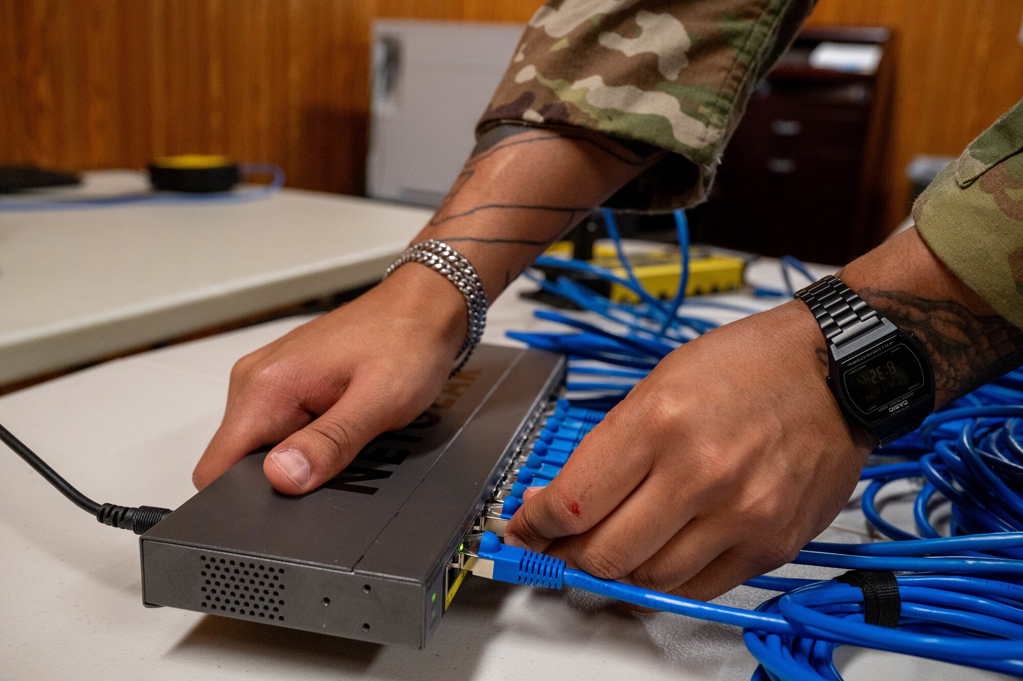 A U.S. Air Force Airman assigned to the 623rd Air Control Squadron connects network cables during a communication outage exercise at Kadena Air Base, Japan, Nov. 14, 2024.