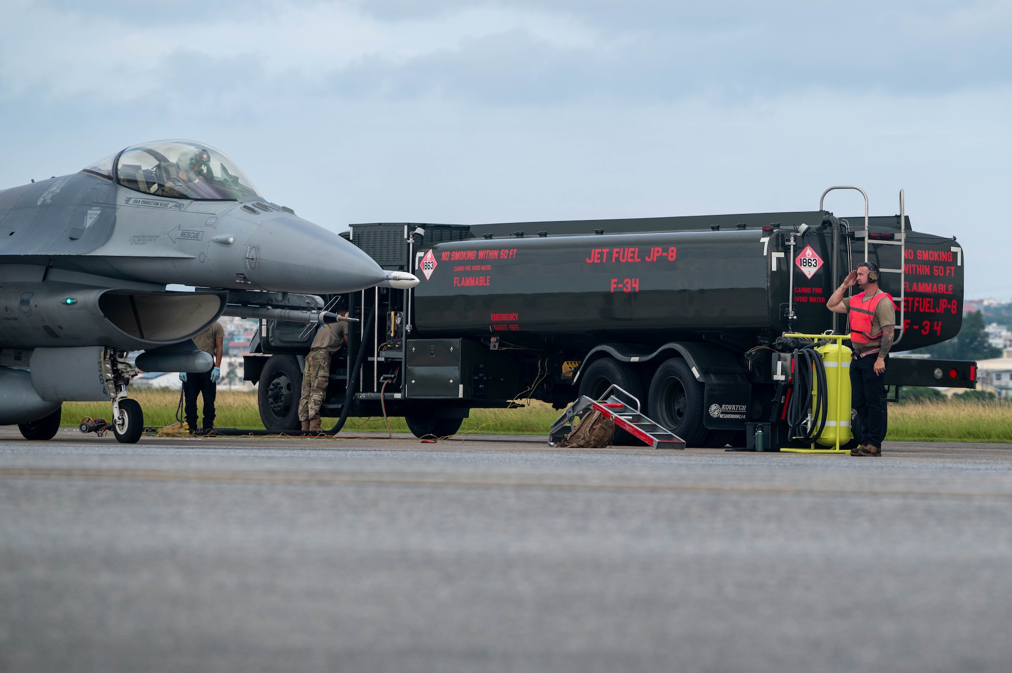 A crew chief assigned to the 77th Expeditionary Fighter Generation Squadron salutes the pilot of an F-16 Fighting Falcon as they begin to taxi to the runway during a communication outage exercise at Kadena Air Base, Japan, Nov. 14, 2024.