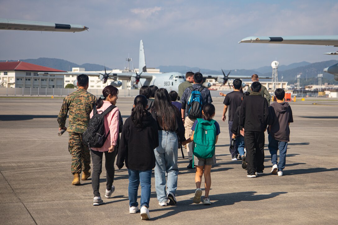 U.S. Marines with Marine Aerial Refueler Transport Squadron (VMGR) 152, Marine Aircraft Group 12, 1st Marine Aircraft Wing give a tour of the Marine Corps Air Station Iwakuni flightline to children from a local orphanage during a community relations event at MCAS Iwakuni, Japan, Nov. 4, 2024. The MCAS Iwakuni chapel hosted a community relations event with a local orphanage in which 20 children were provided the opportunity to interact with U.S. aircraft. (U.S. Marine Corps photo by Lance Cpl. Rylan Adcock)