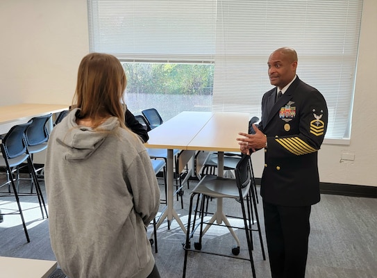 Master Chief Phillip Jean-Gilles, command master chief of the Naval Medical Research Command, shares his experience serving as a hospital corpsman in the U.S. Navy with Kansas City area high school students during Navy Week in Kansas City, Nov. 12, 2024. Navy Weeks are part of outreach efforts intended to educate the American public on the Navy’s capabilities and relevance to national security.(U.S. Navy photo by Malcolm McClendon)