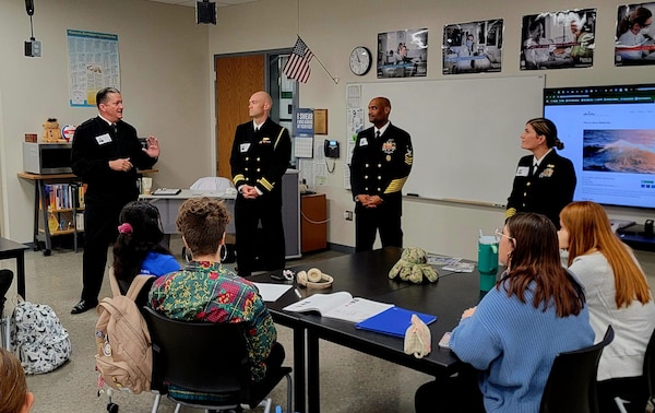 Left to right, Rear Adm. Walter Brafford, commander of the Naval Medical Forces Development Command and chief of the Navy Dental Corps, Lt. Cmdr. Zachery Pommer, flag aide to the commander of the NMFDC, Master Chief Phillip Jean-Gilles, command master chief of the Naval Medical Research Command, and Capt. Shauna O'Sullivan, rheumatologist and Navy Medical Corps career planner, share their experience serving as medical professionals in the U.S. Navy with Kansas City area high school students during Navy Week in Kansas City, Nov. 13, 2024. Navy Weeks are part of outreach efforts intended to educate the American public on the Navy’s capabilities and relevance to national security. (U.S. Navy photo by Malcolm McClendon)