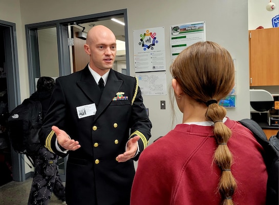 Lt. Cmdr. Zachery Pommer, flag aide to the commander of the Naval Medical Forces Development Command, shares his experience serving as a dentist in the U.S. Navy with Kansas City area high school students during Navy Week in Kansas City, Nov. 13, 2024. Navy Weeks are part of outreach efforts intended to educate the American public on the Navy’s capabilities and relevance to national security. (U.S. Navy photo by Malcolm McClendon)