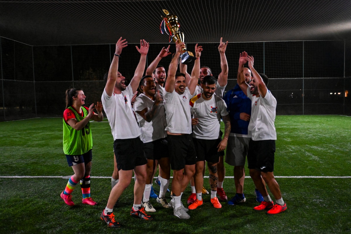 A group of people celebrate soccer win