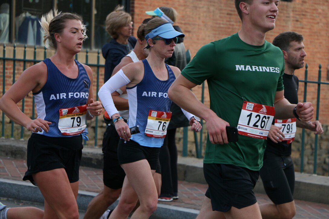 Air Force 1st Lt. Caroline Wittich of Patrick SFB, Florida (bib 79) and Lt Col Amy Natalini, Pentagon, VA (bib 76) on the course of the 2024 Armed Forces Marathon Championship held in conjunction with the 49th Marine Corps Marathon in Washington, D.C.  The Armed Forces Championship features teams from the Army, Marine Corps, Navy (with Coast Guard runners), and Air Force (with Space Force Runners).  Department of Defense Photo by Mr. Steven Dinote - Released.