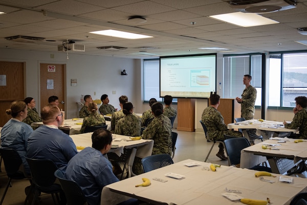 01-	Lt. Cmdr. Jake Wittenauer, DSc- PA-C, Deputy Director of Naval Health Clinic Cherry Point’s Medical Services instructs Corpsmen serving aboard the facility on the layers of tissue composing human skin Friday, November 15.  Wittenauer’s presentation was part of a class teaching the Corpsmen how to properly suture a wound closed.