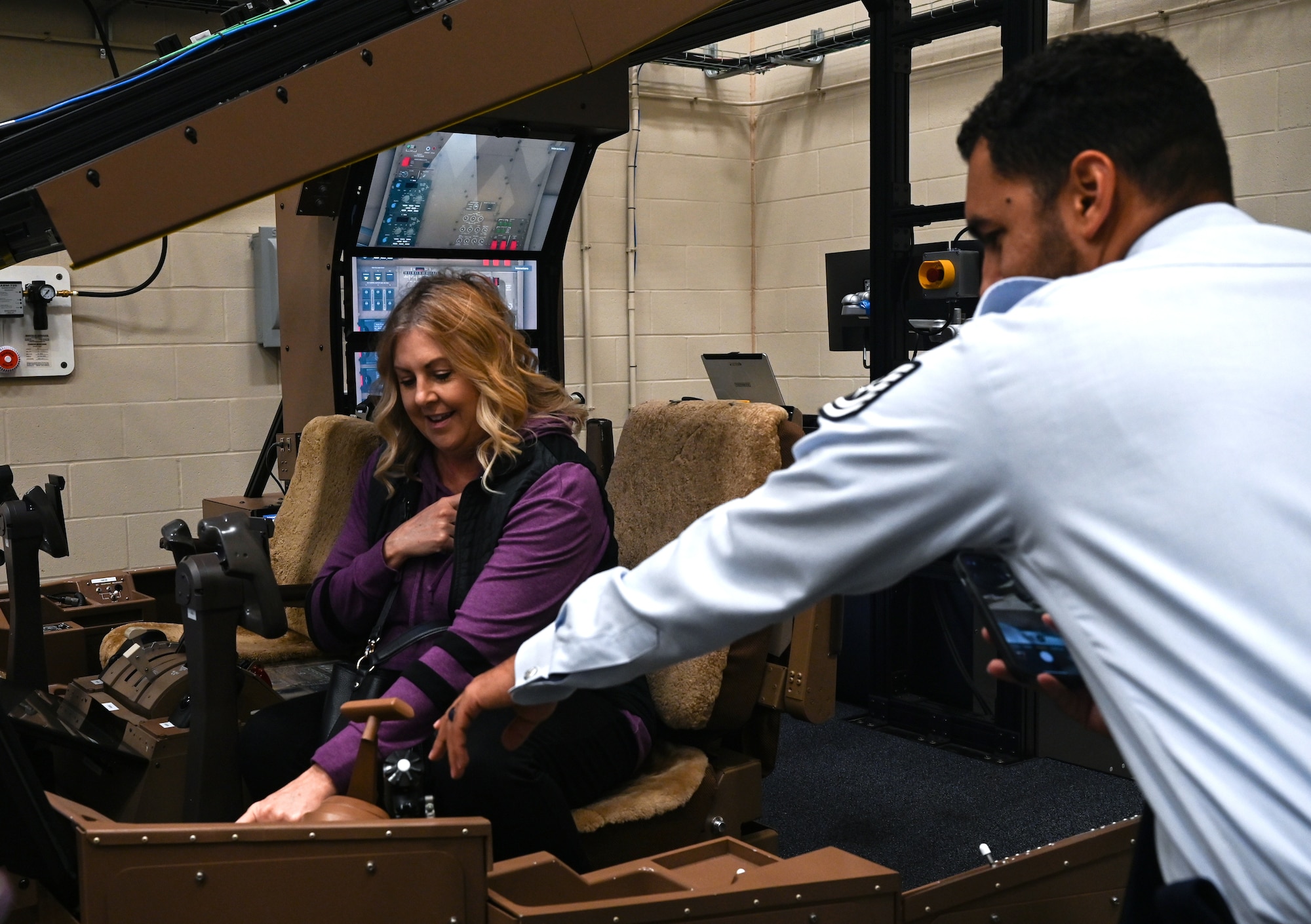Tech. Sgt. Joseph Lindgren, right, 349th Recruiting Squadron recruiter, shows Dana Houser, Douglas High School counselor, inside a KC-46A Pegasus maintenance simulator during a base tour Nov. 6, 2024, at McConnell Air Force Base, Kansas. The purpose of the tour was to offer deeper insight into life in the military for local guidance counselors and military liaisons, as well as provide an opportunity for them to develop working relationships with active duty, Guard and Reserve recruiters. (U.S. Air Force photo by Staff Sgt. Tryphena Mayhugh)