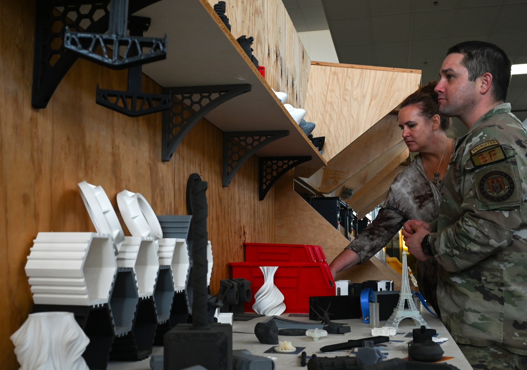 Participants in a base tour for local high school and college guidance counselors and military liaisons and Kansas active duty, Guard and Reserve recruiters look at 3-D printed items in the 22nd Air Refueling Wing Innovation Lab Nov. 6, 2024, at McConnell Air Force Base, Kansas. The purpose of the tour was to offer deeper insight into life in the military for local guidance counselors and military liaisons, as well as provide an opportunity for them to develop working relationships with active duty, Guard and Reserve recruiters. (U.S. Air Force photo by Staff Sgt. Tryphena Mayhugh)