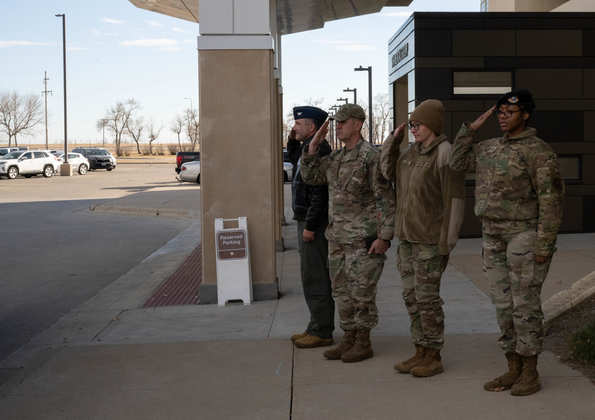 U.S. Air Force Col. Jesse Lamarand, 5th Bomb Wing commander, alongside U.S. Air Force Col. Shaun Westphal, 5th Medical Group Commander, and personnel from the 5BW, salute U.S. Air Force Brigadier Gen. Mark Richey, mobilization assistant to the commander, Eighth Air Force, and Joint-Global Strike Operations Center at Minot Air Force Base, North Dakota, Nov. 14, 2024. Richey visited the 5MDG and familiarized himself with its functions and mission. (U.S. Air Force photo by Airman 1st Class Wesley Davies)