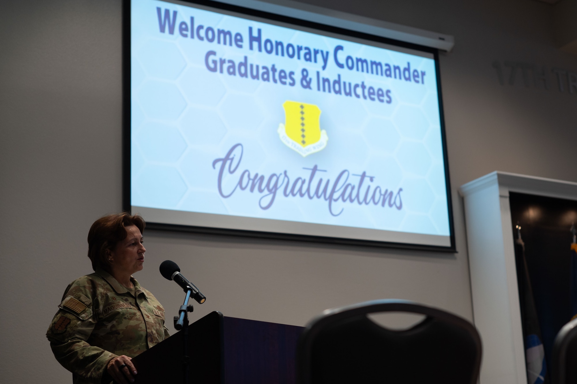 U.S. Air Force Col. Angelina Maguinness, 17th Training Wing commander, speaks during the 2024 Honorary Commander Graduation and Induction ceremony at the Powell Event Center, Goodfellow Air Force Base, Texas, Nov. 7, 2024. Maguinness spoke on the importance of the Honorary Commander program and how it reinforces the connection between Goodfellow and the surrounding community. (U.S. Air Force photo by Airman 1st Class Brian Lummus)