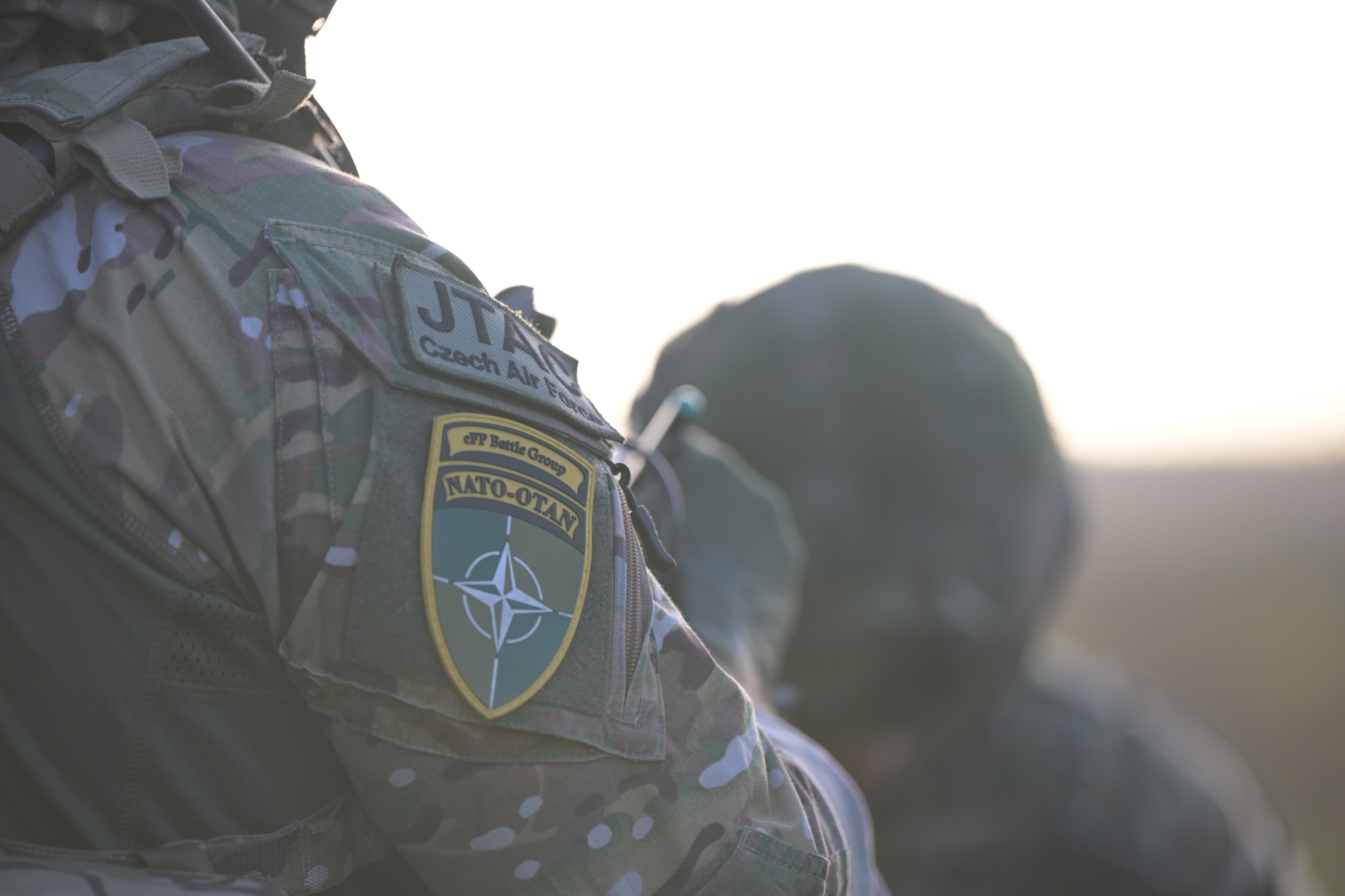 A close-up photo of 2 patches worn on a military person's right arm. The top patch says "JTAC Czech Air Force" and directly underneath that patch is a patch that displays the text "cFP Battle Group" and "NATO - OTAN" above the NATO symbol.