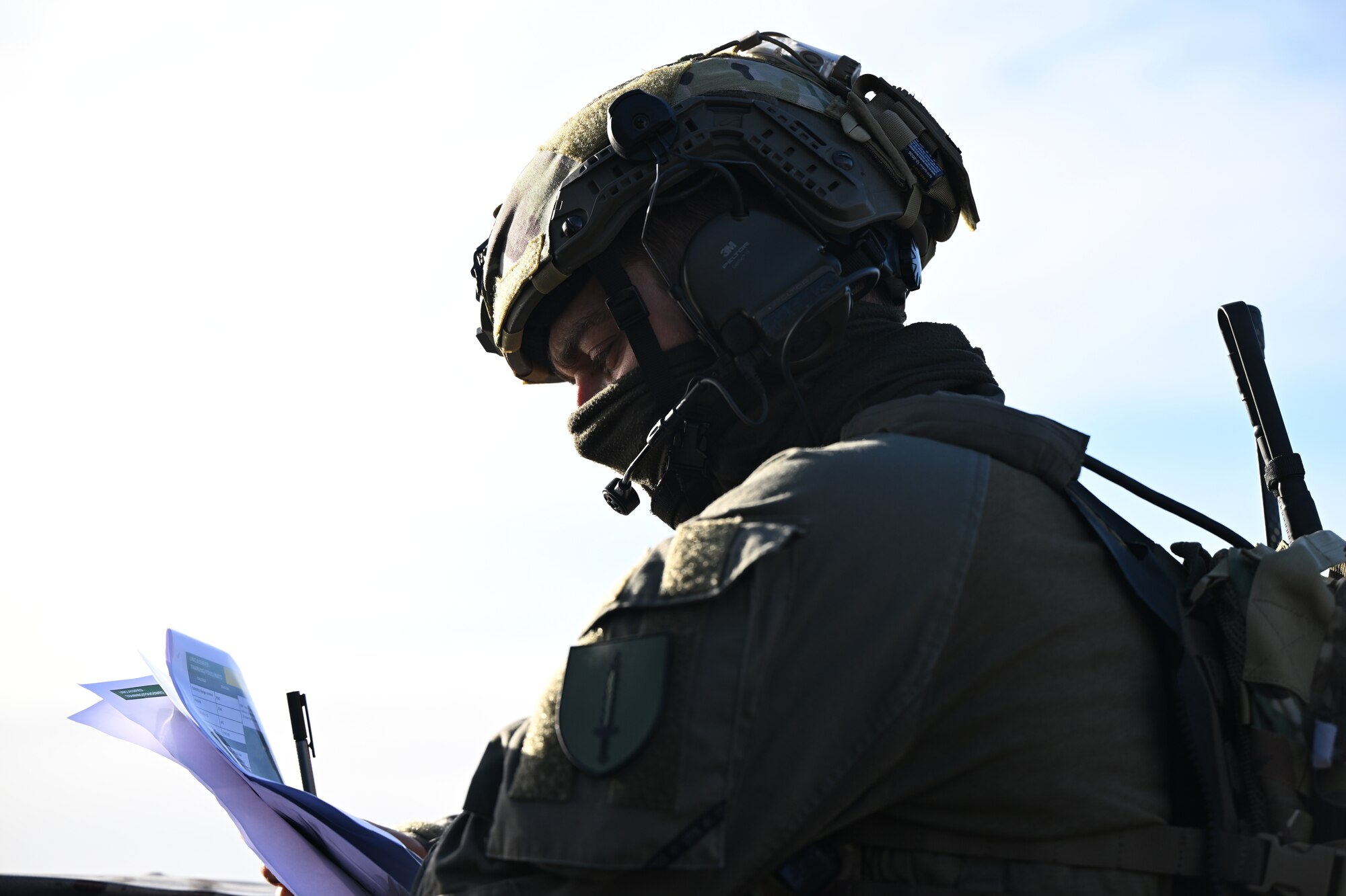 A person looks at the text and charts on some papers they're holding.