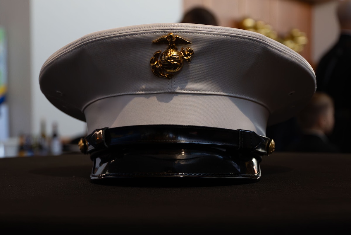 U.S. Marine Corps Dress Blues Cover during the 249th Marine Corps Ball action at the CJ Davidson Conference Center in San Angelo, Texas, Nov. 9, 2024. Marines are authorized to wear covers indoors when on duty status or wearing a side-arm or pistol belt unless a meal or religious service is in progress. (U.S. Air Force photo by Airman 1st Class Brian Lummus)