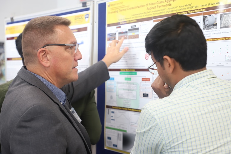 CRREL’s Acting Director Dr. Ivan Beckman reviews a Rowan University student’s research findings during a poster session held during Rowan University’s visit to CRREL.