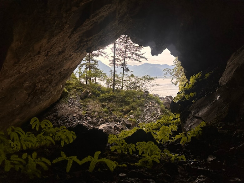 Cave entrance on Baker Island overlooking mountains and ocean