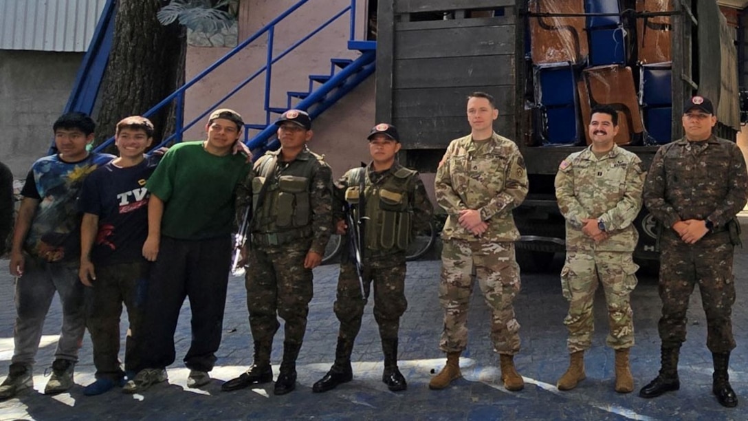 U.S. Army Captain Giovanni Valldejuli and Sgt 1st Class Clayton Gransberg from the Civil Affairs team facilitate the pick up of a desk donation for schools throughout the Izabal region in Guatemala with three members of the Guatemalan Navy, Oct. 25, 2024. The Civil Affairs team serves as a liaison between the Guatemalan military, United States Agency for International Development, and the fabrication warehouse to ensure a seamless process from beginning to end for the betterment of our partner nations and their communities. (U.S. Army courtesy photo)