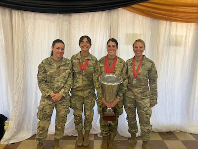 The four top-scoring members of the New York National Guard women’s team pose with their medals and a trophy at the South African National Defence Force Military Skills Competition in Potchefstroom, South Africa, Nov. 2, 2024. From left, Air National Guard Senior Airman Alexa Reeves, Senior Airman Jayla Decicco, Senior Airman Vincenza Costanzo and Army National Guard Staff Sgt. Stacey Hart.