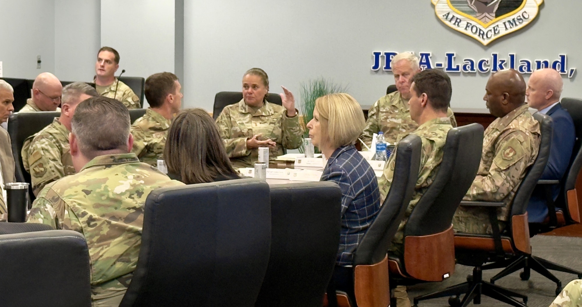 AFIMSC Airmen and civilians sitting at a table participating in a discussion.