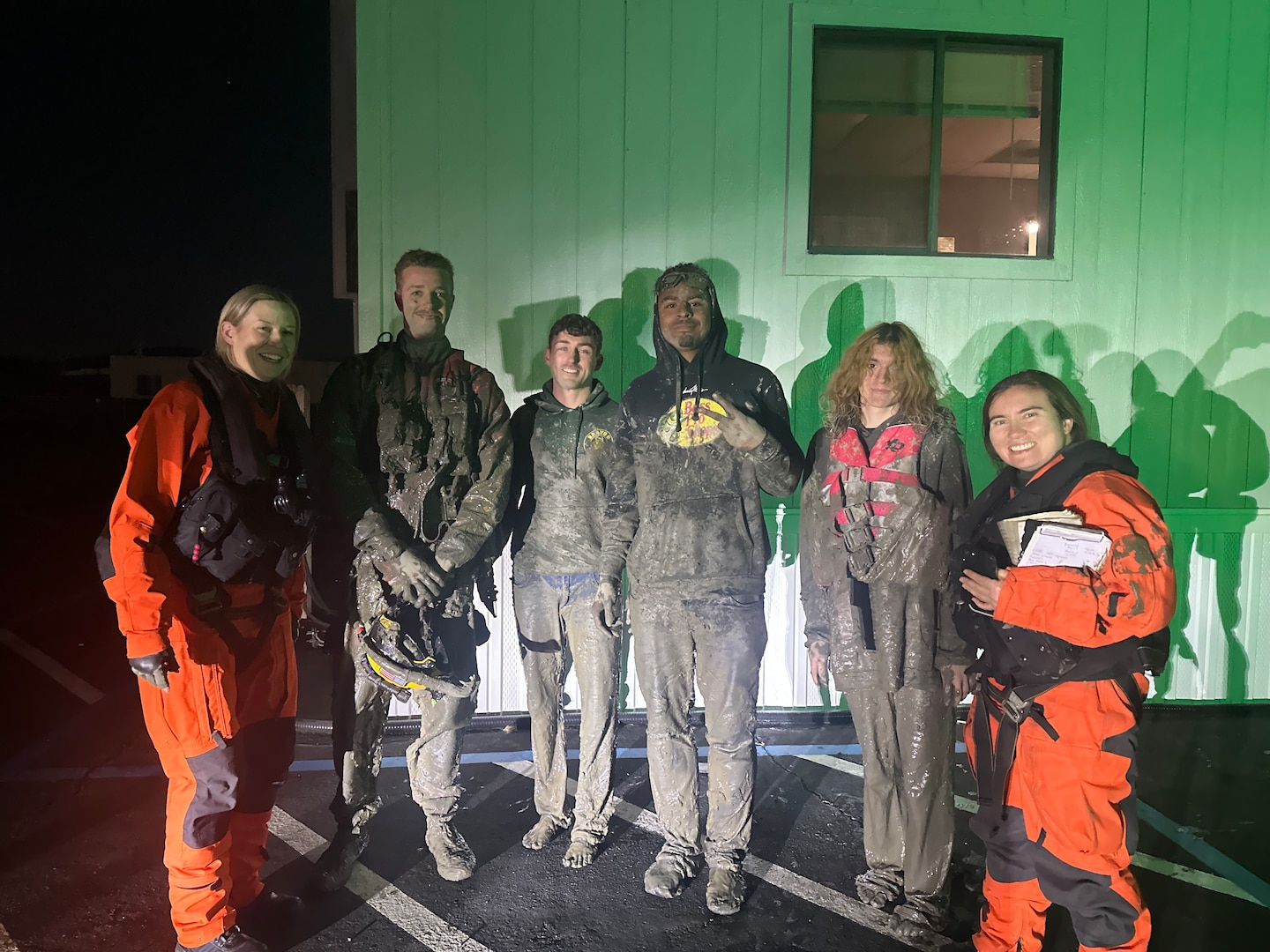 Two Coast Guard Air Station San Francisco pilots pose for group photo with three individuals at Napa County Airport, California, after rescuing them from their boat in San Pablo Bay, Nov. 15, 2024. After their boat became grounded the individuals attempted to walk to shore in the mud but needed to board their boat again. (Coast Guard photo)