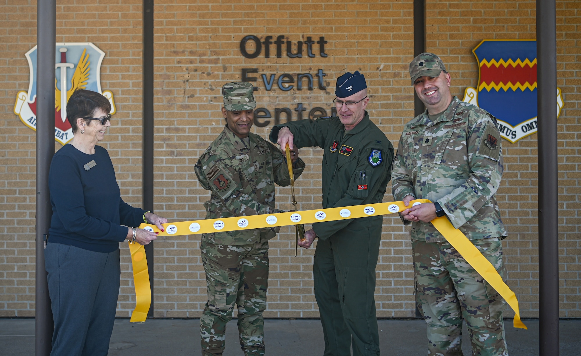 People cut ribbon during ceremony
